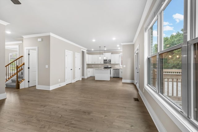 unfurnished living room featuring ceiling fan, crown molding, and dark wood-type flooring