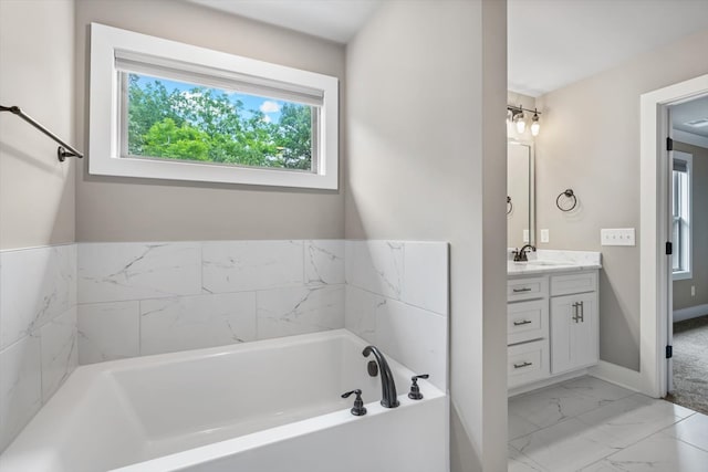 bathroom with a washtub, tile floors, and vanity with extensive cabinet space