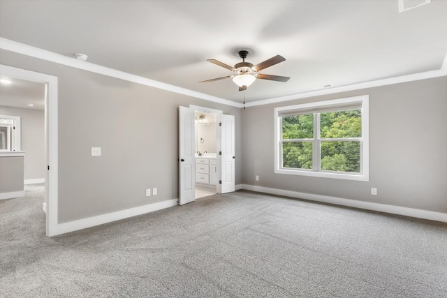 unfurnished bedroom with ceiling fan, ensuite bathroom, ornamental molding, and light carpet