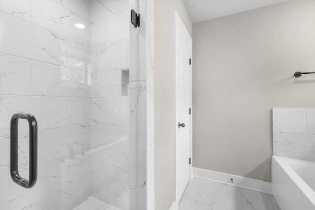 bathroom with tile floors and a tile shower