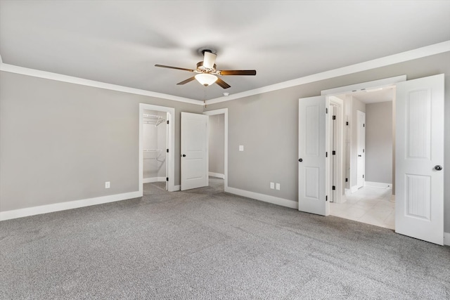 carpeted empty room featuring crown molding and ceiling fan