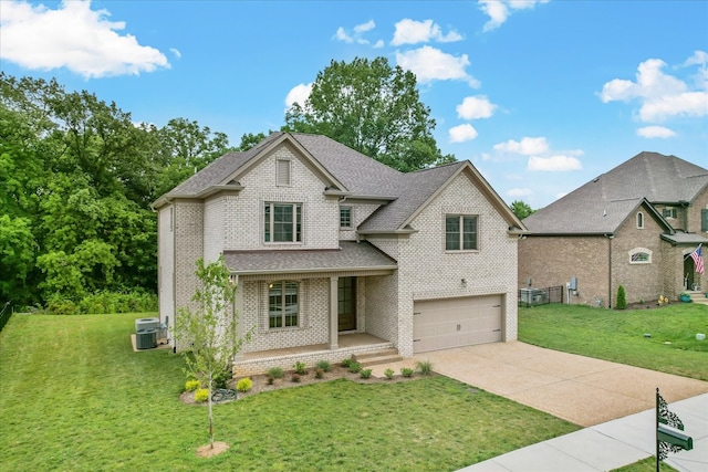 view of front of home with central AC, a front lawn, and a garage