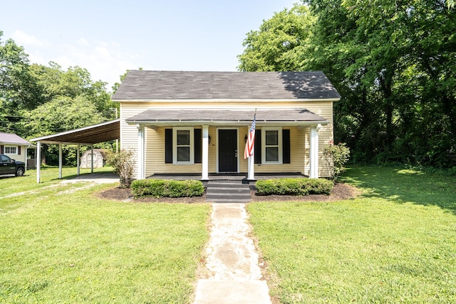 bungalow-style home with a front lawn, covered porch, and a carport