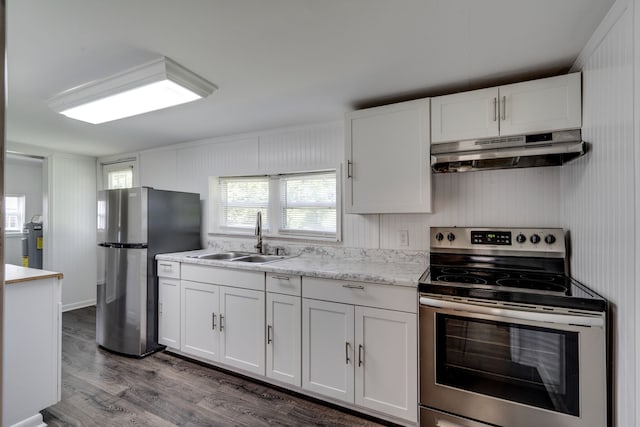 kitchen featuring sink, stainless steel appliances, white cabinetry, and hardwood / wood-style flooring