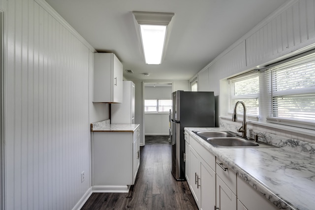 kitchen with white cabinets, dark hardwood / wood-style flooring, sink, and ornamental molding