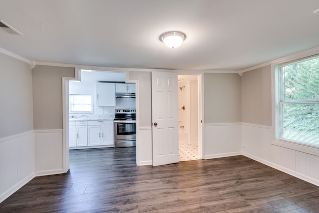 kitchen with white cabinets, a healthy amount of sunlight, dark hardwood / wood-style floors, and stainless steel electric range oven