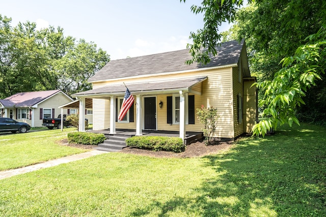 view of front of home with covered porch and a front yard