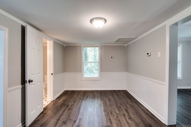 empty room with dark wood-type flooring and ornamental molding