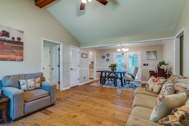 living room featuring light hardwood / wood-style floors, high vaulted ceiling, beam ceiling, french doors, and ceiling fan with notable chandelier