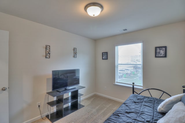 bedroom featuring light colored carpet