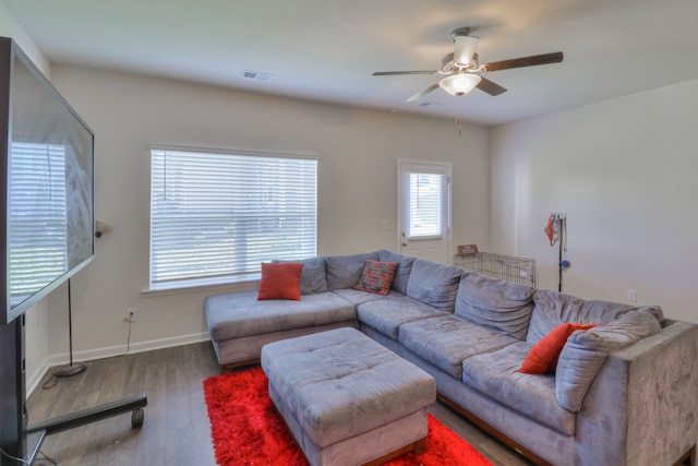 living room featuring dark hardwood / wood-style floors and ceiling fan