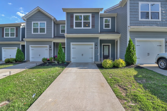 view of property with a front yard and a garage