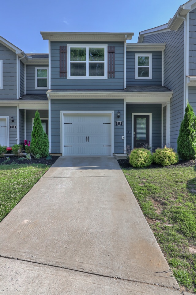 view of front facade featuring a front yard and a garage