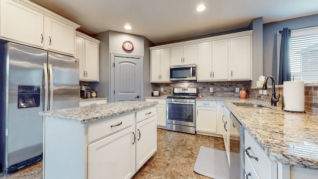 kitchen featuring sink, appliances with stainless steel finishes, backsplash, and light tile flooring