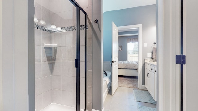 bathroom featuring tile floors, an enclosed shower, and vanity