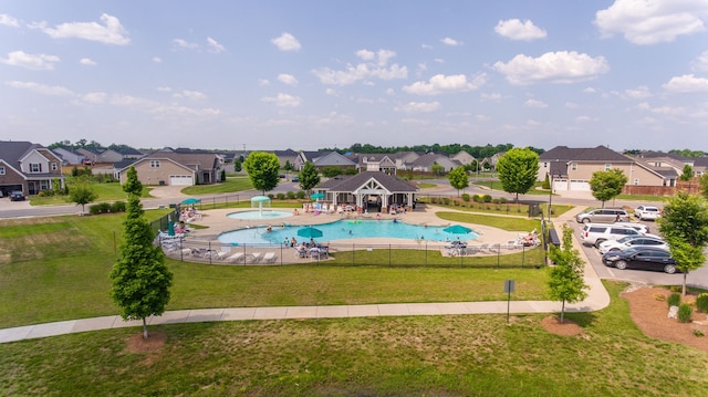 view of swimming pool with a yard