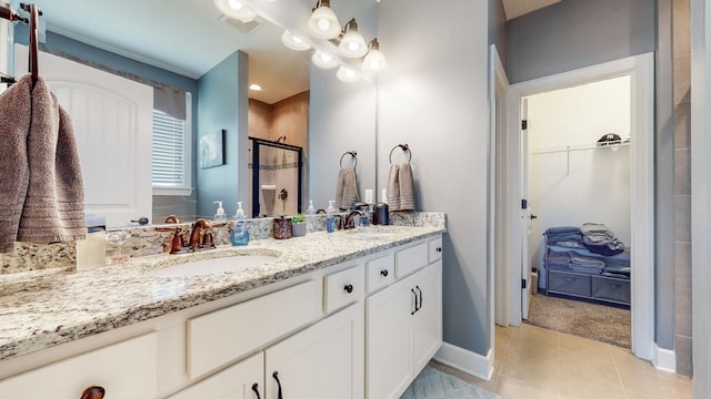 bathroom with oversized vanity, double sink, and tile flooring