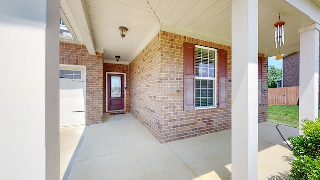 entrance to property featuring a porch and a garage