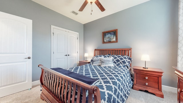 bedroom featuring ceiling fan, a closet, light colored carpet, and lofted ceiling