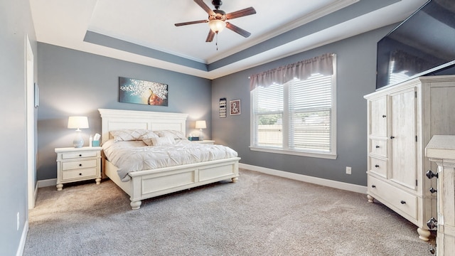 carpeted bedroom featuring a raised ceiling, crown molding, and ceiling fan