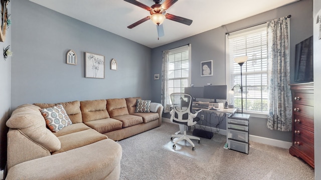 carpeted home office with ceiling fan