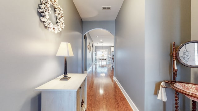 hallway with light hardwood / wood-style floors