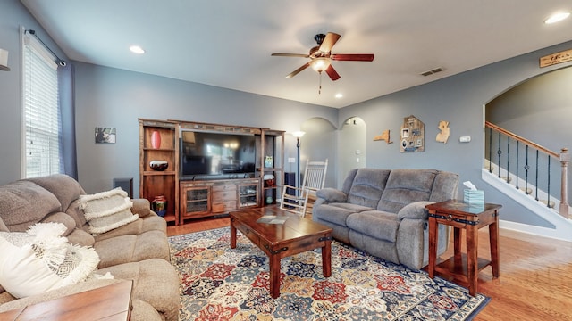 living room featuring light hardwood / wood-style floors and ceiling fan