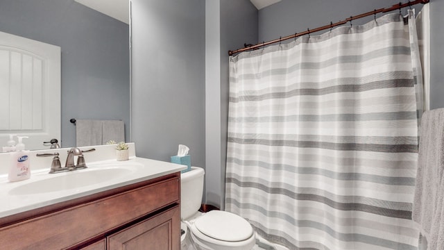 bathroom featuring oversized vanity and toilet