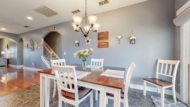 dining space featuring a chandelier and dark hardwood / wood-style flooring