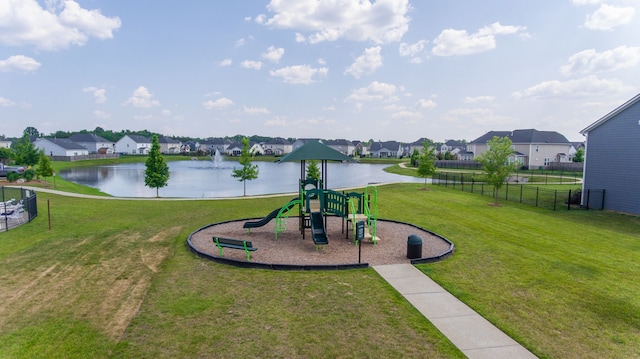 view of nearby features with a water view, a yard, and a playground