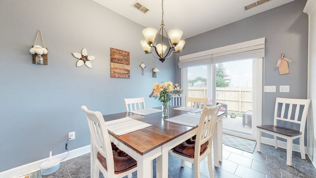 tiled dining area with an inviting chandelier