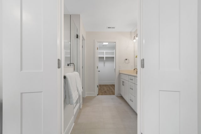 bathroom with tile floors and vanity