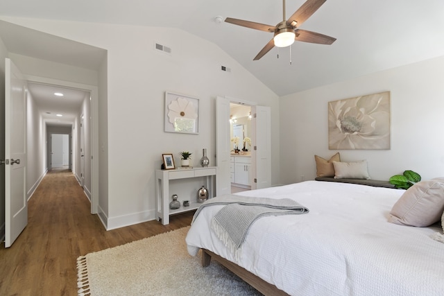 bedroom with lofted ceiling, ensuite bathroom, ceiling fan, and light hardwood / wood-style flooring