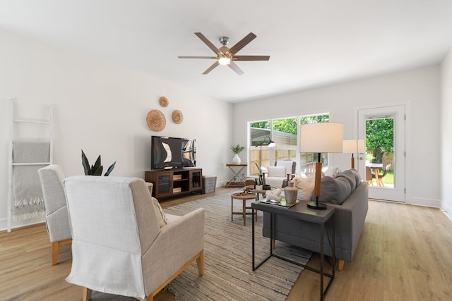 living room featuring ceiling fan and light hardwood / wood-style flooring