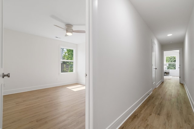 hallway with light hardwood / wood-style flooring