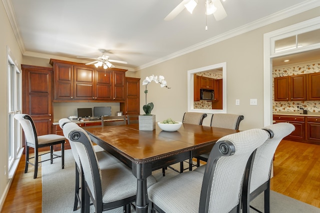 dining area with light hardwood / wood-style floors, ceiling fan, and ornamental molding