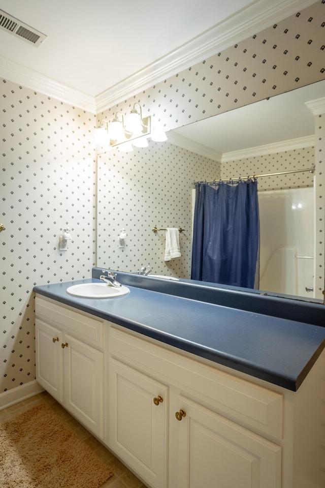 bathroom with ornamental molding and vanity