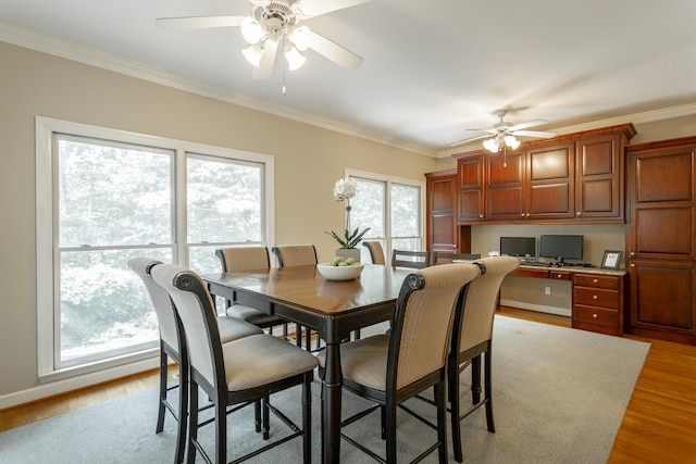 dining space with a healthy amount of sunlight, light hardwood / wood-style floors, ceiling fan, and crown molding