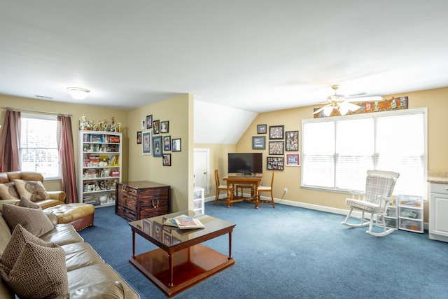 living room with ceiling fan, dark carpet, and a healthy amount of sunlight