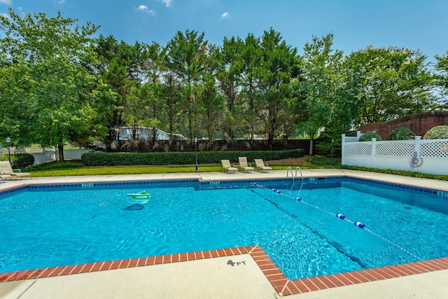 view of pool featuring a yard