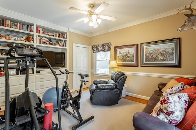 workout area with ceiling fan, light hardwood / wood-style flooring, and ornamental molding