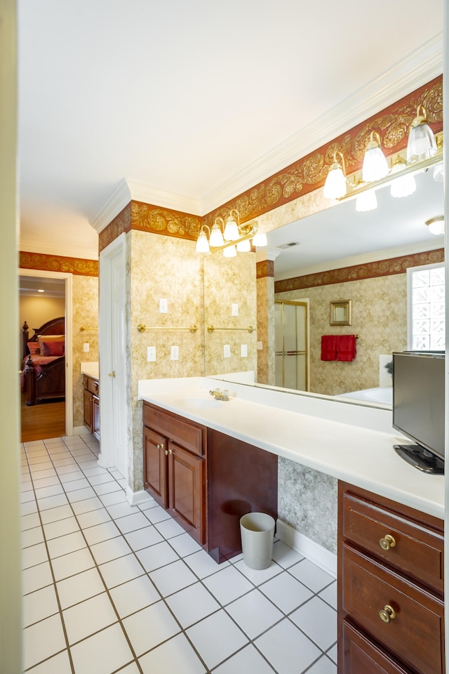 bathroom with crown molding, tile floors, and vanity