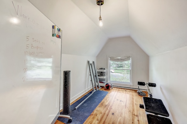 workout area with vaulted ceiling and wood-type flooring