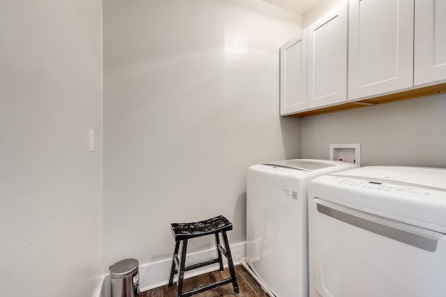 laundry area with washing machine and clothes dryer, dark wood-type flooring, cabinets, and hookup for a washing machine