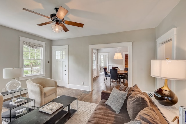 living room featuring ceiling fan and light hardwood / wood-style floors