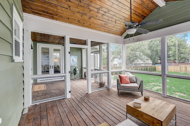 unfurnished sunroom featuring plenty of natural light, vaulted ceiling, wooden ceiling, and ceiling fan