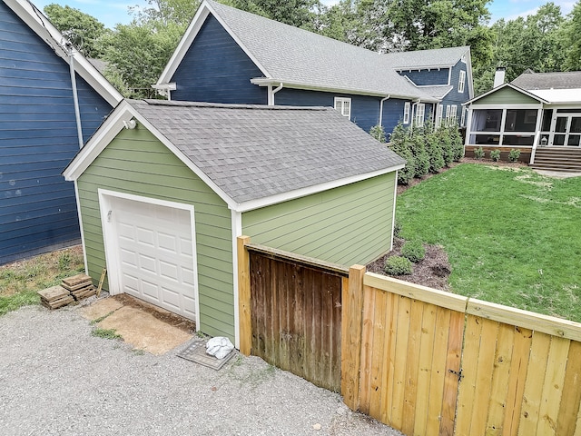 garage featuring a yard and wood walls