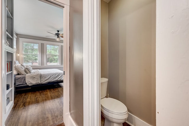 bathroom with hardwood / wood-style floors, toilet, and ceiling fan