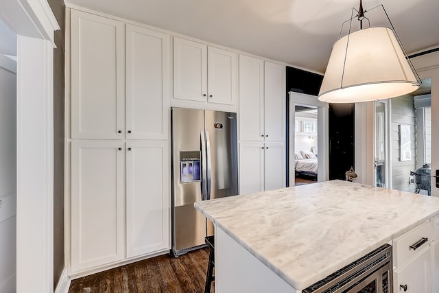 kitchen featuring white cabinetry, appliances with stainless steel finishes, and dark hardwood / wood-style flooring