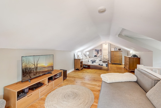 interior space featuring lofted ceiling and light hardwood / wood-style flooring